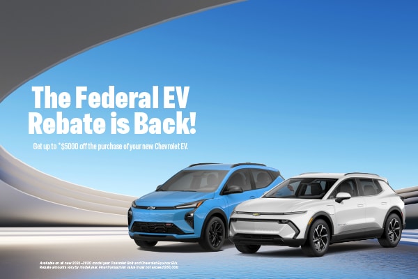 Two Chevrolet electric SUVs with a banner announcing the federal EV rebate return.