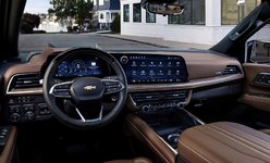 Chevrolet SUV interior featuring a modern dashboard, steering wheel, and digital display in a parked setting.