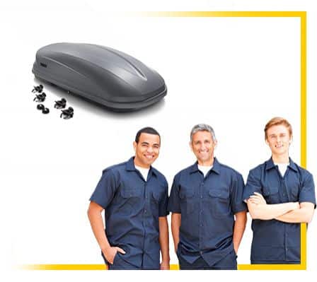 Roof cargo box with mounting hardware above three smiling men in blue uniforms.